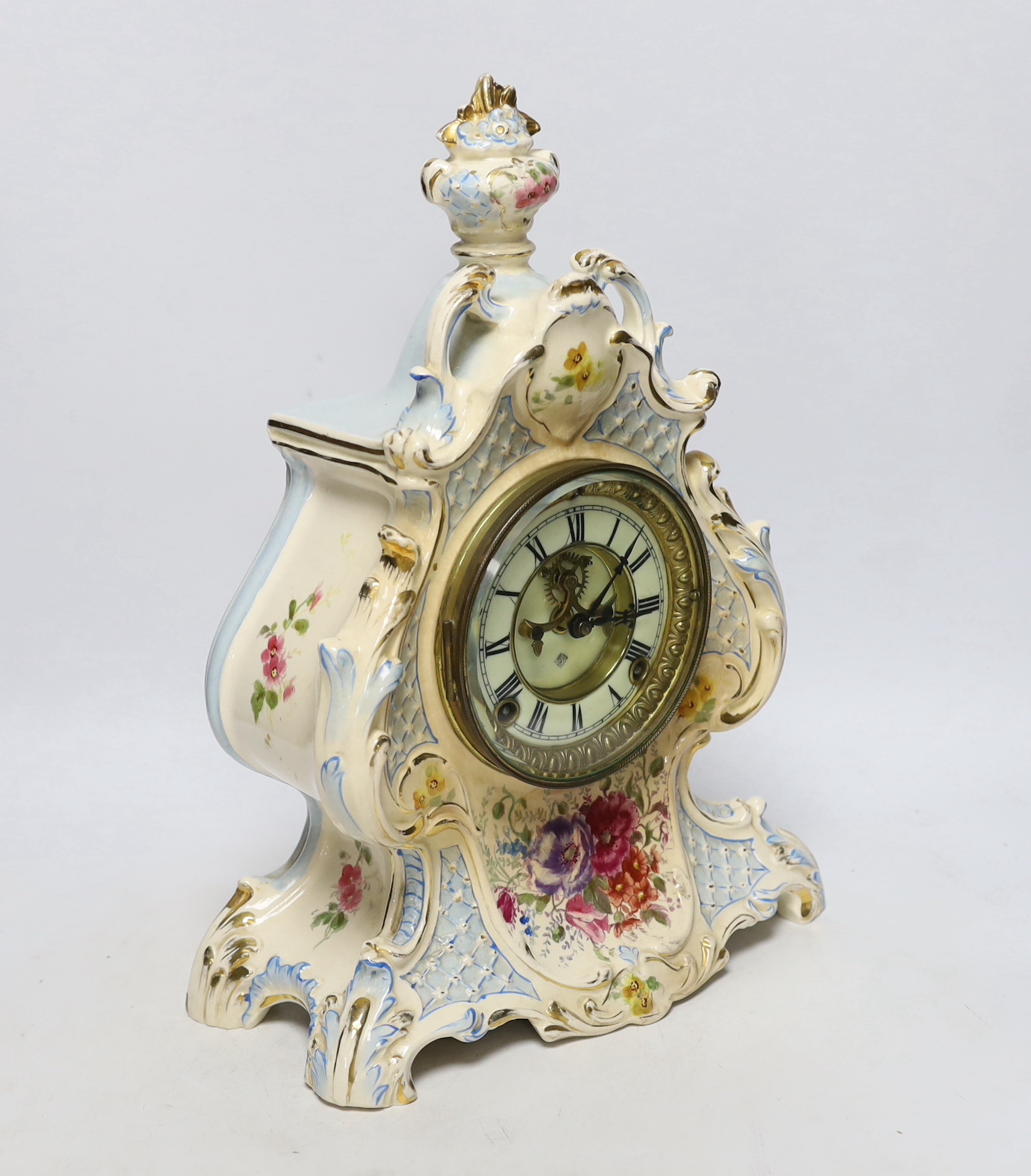 A Royal Bonn pottery mantel clock with Ansonia movement, striking on a coiled gong, 37cm high